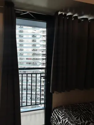 a bedroom with a window with a view of a building at 