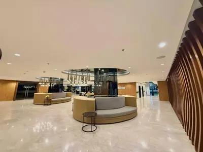 a lobby with couches and chairs in a building at Liwayway Suites in Manila