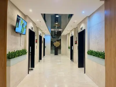 a hallway in a building with a tv on the wall at Liwayway Suites in Manila