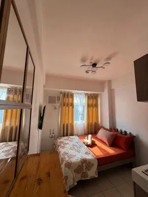 a bedroom with a bed and a ceiling fan at PaulBert's Cabins II in Sampong