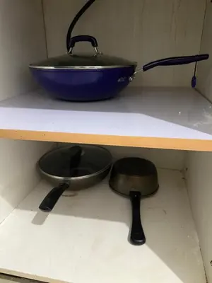 a bowl and pans on a shelf in a kitchen at 2 Bedroom staycation at Jazz Residences Makati and Paid Private Parking in Manila