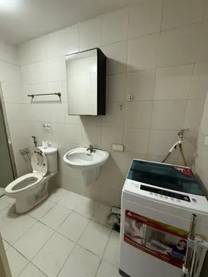 a small bathroom with a toilet and a sink at 2 Bedroom staycation at Jazz Residences Makati and Paid Private Parking in Manila