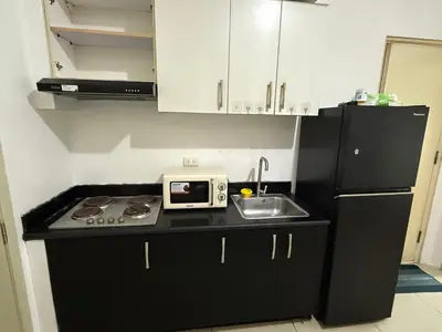 a small kitchen with a sink and a microwave at 2 Bedroom staycation at Jazz Residences Makati and Paid Private Parking in Manila