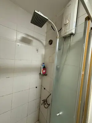 a shower in a bathroom with a fan at 2 Bedroom staycation at Jazz Residences Makati and Paid Private Parking in Manila