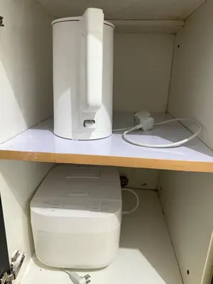 a computer monitor and a printer sitting on a shelf at 2 Bedroom staycation at Jazz Residences Makati and Paid Private Parking in Manila