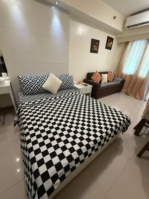 a bedroom with a black and white checkered bed at Sea Residences Staycation Near MOA Pasay City by Rose in Manila
