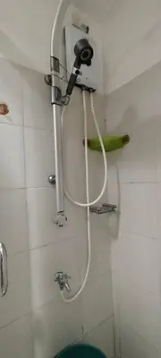 a shower in a bathroom with a hose on the wall at Sea Residences Staycation Near MOA Pasay City by Rose in Manila