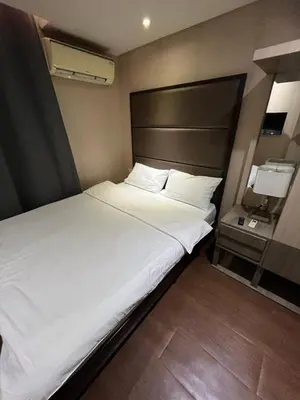 a large white bed in a small room at The Serenity Tower 90BB in Manila