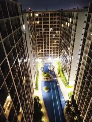 an aerial view of a hotel with a pool between two buildings at Cozy 19 at Shore 2 Residences in Manila