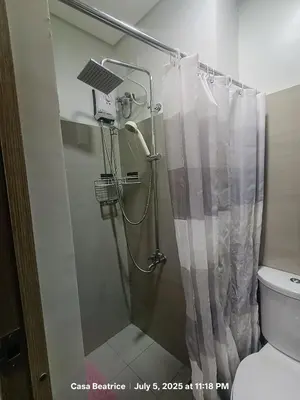 a shower in a bathroom with a shower curtain at Cozy 19 at Shore 2 Residences in Manila