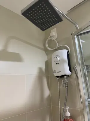 a shower in a bathroom with a light on the ceiling at FAME Residences - The 37th Suite in Manila