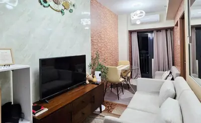 a living room with a television on a wooden entertainment center at Luxe Vintage with Best View MallofAsia Airport in Manila