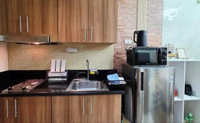a kitchen with a sink and a microwave at Luxe Vintage with Best View MallofAsia Airport in Manila