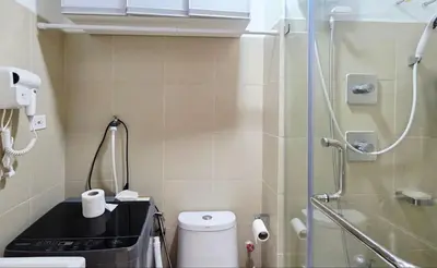a small bathroom with a shower and a toilet at Luxe Vintage with Best View MallofAsia Airport in Manila