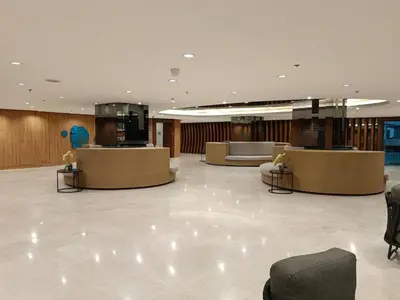 a lobby with desks and couches in a building at shore 2 residences admin in Manila