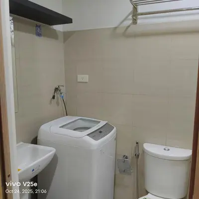 a small bathroom with a toilet and a sink at shore 2 residences admin in Manila