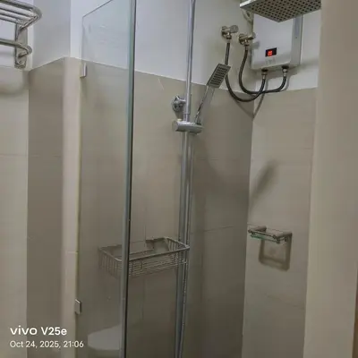 a shower with a glass door in a bathroom at shore 2 residences admin in Manila