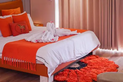 a bedroom with a bed with two swans on it at Luxury Condo at Bayshore Residential Phase 2 beside OKADA & near MOA in Manila