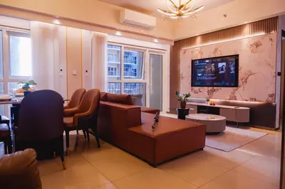 a living room with a couch and a table at Luxury Condo at Bayshore Residential Phase 2 beside OKADA & near MOA in Manila