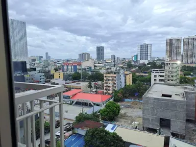 a view of a city from a balcony at Homey Roxas Blvd Condo Pool Parking WiFi in Manila