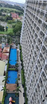 an aerial view of a large building with two pools at Gavinne Place Coast Residences in Manila