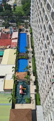 an aerial view of a building with two pools at Gavinne Place Coast Residences in Manila