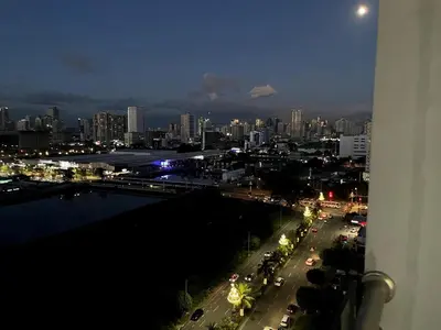 a view of a city at night from a balcony at Perfect Sunset View in Pasay Near MOA & NAIA in Manila