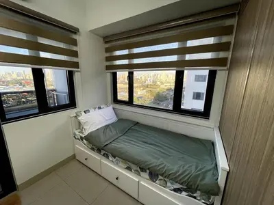 a small room with a bed and two windows at Perfect Sunset View in Pasay Near MOA & NAIA in Manila