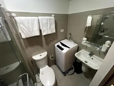 a bathroom with a toilet and a sink at Perfect Sunset View in Pasay Near MOA & NAIA in Manila
