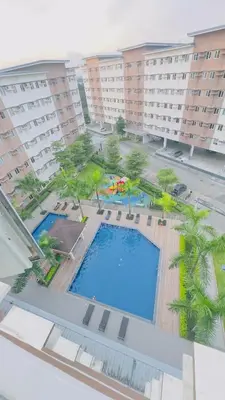 an overhead view of a swimming pool in a resort at Resort Condo in Trece Martires Cavite in Trece Martires