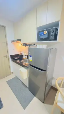 a kitchen with a stainless steel refrigerator in a kitchen at Resort Condo in Trece Martires Cavite in Trece Martires