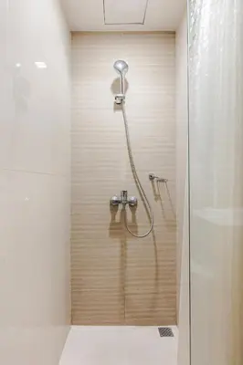 a shower with a shower head in a bathroom at BGC Premium 1BR with Balcony fast 600 mbps Fibre in Manila