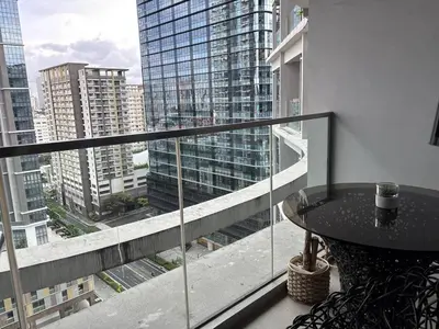 a balcony with a table and a view of a city at BGC Premium 1BR with Balcony fast 600 mbps Fibre in Manila