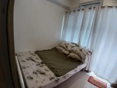 a small bed in a room with a window at Condo unit for rent in Manila