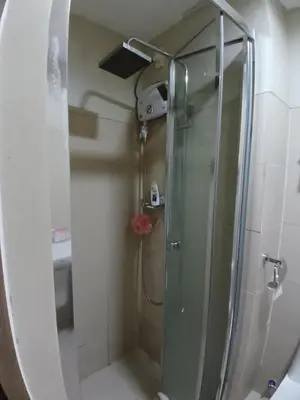 a shower with a glass door in a bathroom at Condo unit for rent in Manila