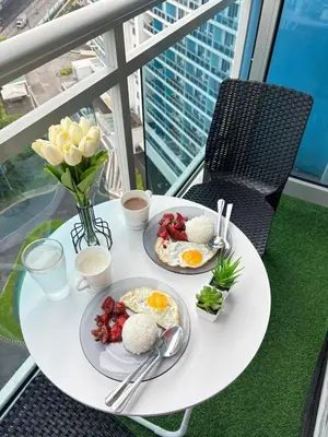 a table with two plates of breakfast food on it at Staycation in Oasis in Manila