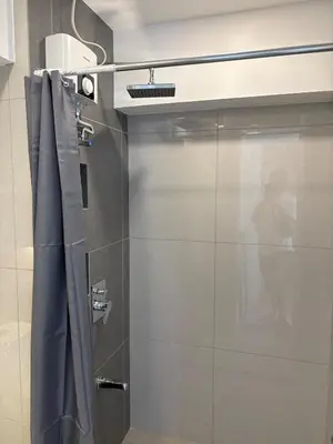 a shower with a sliding door in a bathroom at 3BR golf view in fort victoria BGC in Manila