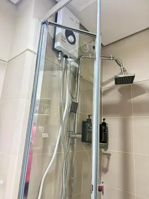 a shower in a bathroom with a glass door at JB Urban Nest at SMDC Fame Residences in Manila