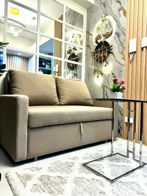 a living room with a couch and a table at JB Urban Nest at SMDC Fame Residences in Manila