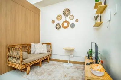 a living room with a couch and a tv at Boho Makati Condo w/ Wi-Fi + Workspace | Red in Manila