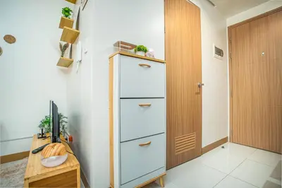 a room with a chest of drawers next to a door at Boho Makati Condo w/ Wi-Fi + Workspace | Red in Manila