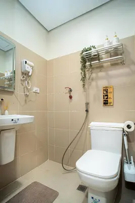 a bathroom with a shower and a toilet and a sink at Boho Makati Condo w/ Wi-Fi + Workspace | Red in Manila