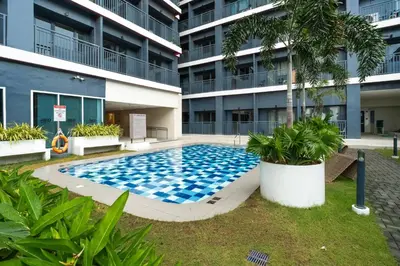 a swimming pool in front of a building at Boho Makati Condo w/ Wi-Fi + Workspace | Red in Manila