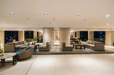 a hotel lobby with couches and tables at Relaxing Hotel Apartment Stay : Near MOA & Airport in Manila