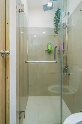 a shower with a glass door in a bathroom at Relaxing Hotel Apartment Stay : Near MOA & Airport in Manila