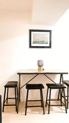 a table with four stools in a room at RTO Staycation in Manila