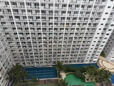 an aerial view of a large building with a pool at Shore 1 Residences Tower D in Manila