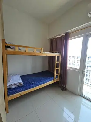 a bedroom with two bunk beds and a window at Shore 1 Residences Tower D in Manila