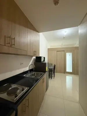 a kitchen with a sink and a counter top at Shore 1 Residences Tower D in Manila