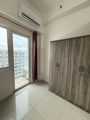 a large room with wooden cabinets and a large window at Shore 1 Residences Tower D in Manila